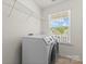 Well-lit laundry room with modern appliances and storage shelves at 112 Serravista St, Mooresville, NC 28117