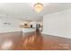 Sun-filled living area featuring hardwood floors, a fireplace, a kitchen with an island, and a staircase at 112 Serravista St, Mooresville, NC 28117