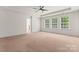 Bright main bedroom featuring three windows for natural light and a ceiling fan at 112 Serravista St, Mooresville, NC 28117