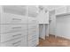 Walk-in closet offers custom shelving, cabinets and ample storage space at 112 Serravista St, Mooresville, NC 28117