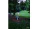 Serene backyard featuring a fire pit and a bird bath surrounded by lush greenery, creating a peaceful oasis at 1165 Old Salisbury Concord Rd, Concord, NC 28025