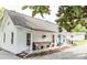Charming exterior of a white home with a welcoming front porch and bench at 1165 Old Salisbury Concord Rd, Concord, NC 28025