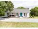 Charming home featuring a welcoming front porch with rocking chairs and a bench, complemented by a blue front door and landscaped yard at 1165 Old Salisbury Concord Rd, Concord, NC 28025