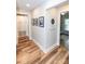 Inviting hallway showcasing hardwood floors, framed photos, and access to multiple rooms at 1165 Old Salisbury Concord Rd, Concord, NC 28025