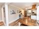Bright and airy kitchen with stainless steel appliances, white cabinets, and a rustic wood table complemented by wood flooring at 1165 Old Salisbury Concord Rd, Concord, NC 28025