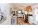 Well-lit kitchen with stainless steel appliances, white cabinets, wood floors, and a decorative vent hood over the stove at 1165 Old Salisbury Concord Rd, Concord, NC 28025
