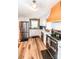Beautiful kitchen with stainless steel appliances, white cabinets, a stainless steel sink, and attractive wood flooring at 1165 Old Salisbury Concord Rd, Concord, NC 28025