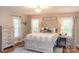 Bright main bedroom with hardwood floors, a comfortable bed, and natural light at 1165 Old Salisbury Concord Rd, Concord, NC 28025