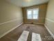 Neutral bedroom with carpet flooring, a large window providing natural light, and simple design at 1218 Forestdale Dr, Salisbury, NC 28144