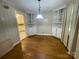 Dining room with hardwood floors, built-in shelving, and a view into the adjacent kitchen at 1218 Forestdale Dr, Salisbury, NC 28144