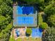 Aerial view of tennis courts, playground, and basketball court surrounded by mature trees at 12404 Mcallister Park Dr, Charlotte, NC 28277