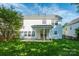 Spacious backyard with a covered patio, lush green lawn, and privacy fence at 12404 Mcallister Park Dr, Charlotte, NC 28277