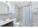 Bathroom with tiled shower and dark vanity at 12404 Mcallister Park Dr, Charlotte, NC 28277