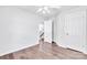 This bedroom features hardwood floors, neutral paint, a ceiling fan, and a view to the stairway at 12404 Mcallister Park Dr, Charlotte, NC 28277