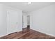 A bedroom with hardwood floors, neutral walls, and a closet and doorway at 12404 Mcallister Park Dr, Charlotte, NC 28277