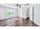 Bright bedroom features hardwood floors, ceiling fan, and a large window at 12404 Mcallister Park Dr, Charlotte, NC 28277
