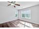 Bedroom with hardwood floors, ceiling fan, neutral walls, and two windows offering plenty of natural light at 12404 Mcallister Park Dr, Charlotte, NC 28277