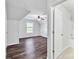 Bedroom featuring hardwood floors, a window view, and an open bathroom doorway at 12404 Mcallister Park Dr, Charlotte, NC 28277