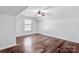 Bedroom featuring hardwood floors, sloped ceilings, and a bright window at 12404 Mcallister Park Dr, Charlotte, NC 28277