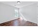 Well-lit bedroom with hardwood floors, neutral walls, and a window providing natural light at 12404 Mcallister Park Dr, Charlotte, NC 28277