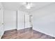 Bright bedroom with hardwood floors, ceiling fan, and neutral paint, offering a calming and inviting space at 12404 Mcallister Park Dr, Charlotte, NC 28277