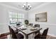 Elegant dining room featuring a modern table set and a window offering natural light at 12404 Mcallister Park Dr, Charlotte, NC 28277