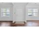 Bright foyer with dark wood floors, white walls, and natural light from windows at 12404 Mcallister Park Dr, Charlotte, NC 28277