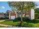 Charming brick home with blue shutters and lush green lawn on a sunny day at 12404 Mcallister Park Dr, Charlotte, NC 28277