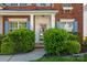 Inviting front porch featuring neatly trimmed bushes and a glass front door at 12404 Mcallister Park Dr, Charlotte, NC 28277