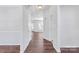 Bright hallway with dark wood floors, white walls, and an arched doorway at 12404 Mcallister Park Dr, Charlotte, NC 28277