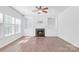 Living room with hardwood floors, a fireplace, and built-in shelves at 12404 Mcallister Park Dr, Charlotte, NC 28277