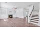 Open-concept living space with fireplace, built-ins, and staircase, featuring hardwood floors at 12404 Mcallister Park Dr, Charlotte, NC 28277