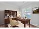 Bright home office with hardwood floors, a desk, and built-in bookshelves at 12404 Mcallister Park Dr, Charlotte, NC 28277