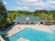 Aerial view of a large swimming pool and clubhouse, perfect for summer fun and relaxation at 12404 Mcallister Park Dr, Charlotte, NC 28277