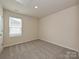 A blank bedroom features an empty carpeted space with a window for natural light at 1441 31St Ne St, Conover, NC 28613