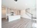 Open-concept living area with hardwood floors, a kitchen island, and a staircase, creating a bright and airy space at 1441 31St Ne St, Conover, NC 28613