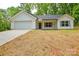 Charming single-story home with white siding, gray shutters, attached garage, and newly seeded front lawn at 164 Hillndale Ln, Statesville, NC 28677