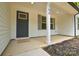 Up close view of front door on porch with white pillars, black door, and the house address of 164 at 164 Hillndale Ln, Statesville, NC 28677