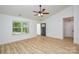 Bright, airy living room boasts wood-look floors, vaulted ceiling with fan, and a view to the outdoors at 164 Hillndale Ln, Statesville, NC 28677