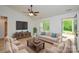 Cozy living room with neutral-toned furniture, a ceiling fan, and a view to the outdoors at 164 Hillndale Ln, Statesville, NC 28677
