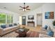 Bright living room with neutral-toned furniture, vaulted ceiling with fan, and stylish decor at 164 Hillndale Ln, Statesville, NC 28677