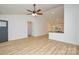 Inviting living area flows into the kitchen, complete with stylish wood-look flooring and a modern ceiling fan at 164 Hillndale Ln, Statesville, NC 28677