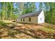 Exterior view of home with sunny skies, lush backyard and mature trees at 164 Hillndale Ln, Statesville, NC 28677