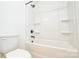 A clean bathroom featuring a white toilet, bathtub, and shower with black fixtures at 164 Hillndale Ln, Statesville, NC 28677