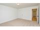 Simple bedroom design with neutral carpet, white walls, and a door to the bathroom at 164 Hillndale Ln, Statesville, NC 28677
