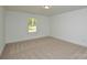 Neutral bedroom with a large window and base trim, offering a serene atmosphere at 164 Hillndale Ln, Statesville, NC 28677