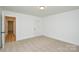A bedroom featuring neutral carpet, white walls, and a door leading to another room at 164 Hillndale Ln, Statesville, NC 28677