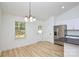 Kitchen with stainless appliances and view of light-filled dining area with window at 164 Hillndale Ln, Statesville, NC 28677