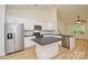 Bright kitchen boasts stainless appliances, central island, and light wood-look flooring at 164 Hillndale Ln, Statesville, NC 28677