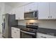 Close up of a modern kitchen with stainless steel appliances and white cabinetry at 164 Hillndale Ln, Statesville, NC 28677